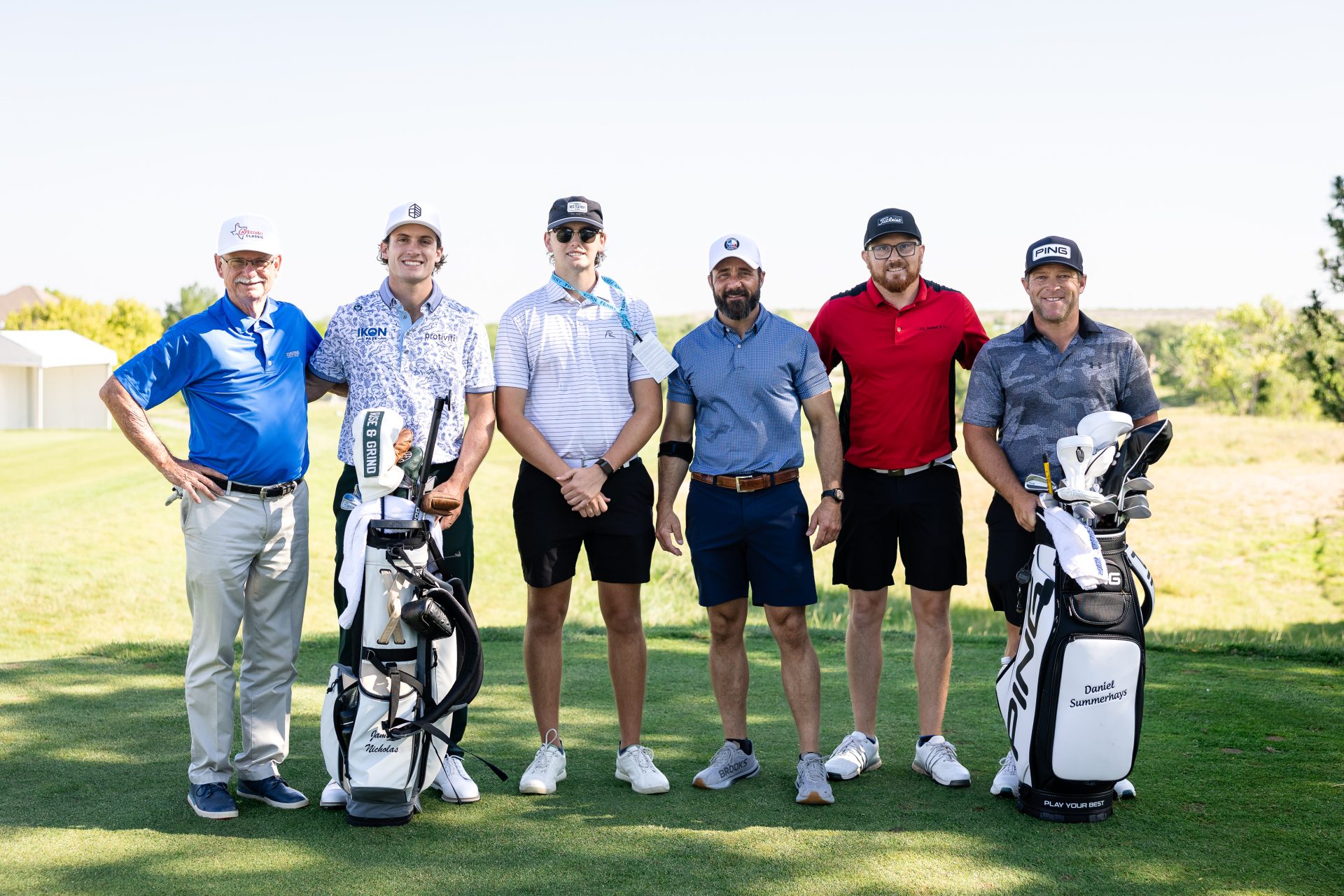 Five men on a golf course celebrating a win during their Pro-Am round of golf